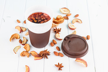 Cup of tea with dried apples, spices, fruits