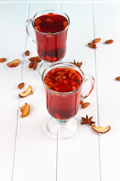 Glass cup of tea with hibiscus and lemon, cinnamon