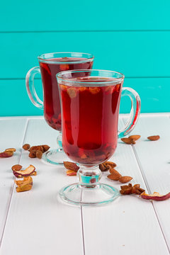 Glass cup of tea with hibiscus and lemon, cinnamon