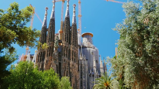 Steadicam shot: The famous temple of the Sagrada Familia in Barcelona, the camera moves in the direction of the church