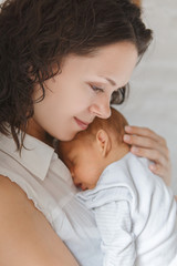 Newborn baby boy in mother's arms
