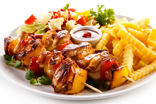 Kebab - grilled meat and vegetables on white background 