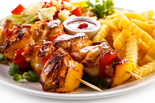 Kebab - grilled meat and vegetables on white background 