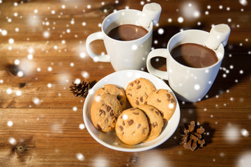 cups of hot chocolate with marshmallow and cookies