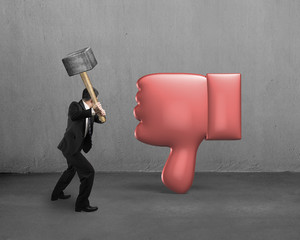 Businessman holding hammer hitting dislike thumb down
