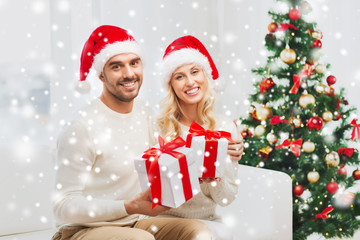 happy couple at home with christmas gift boxes