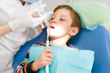 Boy and dentist during a dental procedure