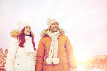 happy couple walking over winter background