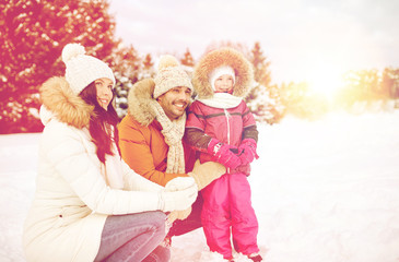 happy family with child in winter clothes outdoors