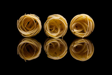 Nest pasta on black background