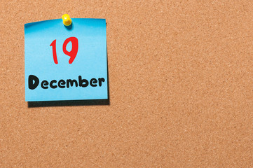 December 19th. Day 19 of month, Calendar on cork notice board. Winter time. Empty space for text
