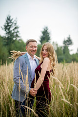 Portrait loving and happy pregnant couple resting in nature
