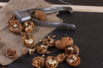 walnuts and nutcracker on table covered with burlap