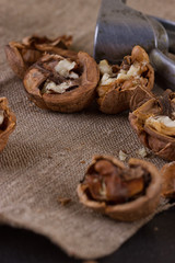 walnuts and nutcracker on table covered with burlap