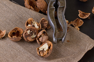 walnuts and nutcracker on table covered with burlap