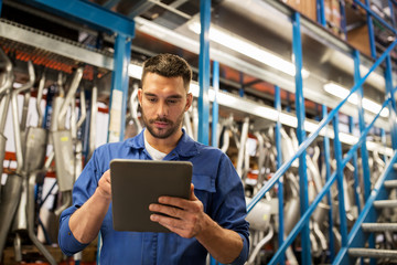 auto mechanic or smith with tablet pc at workshop