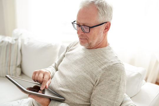 Senior Man With Tablet Pc At Home