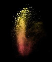 Explosion of colored powder on black background