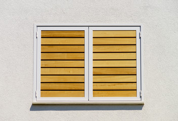Window with shutters closeup view, sunny day on sea resort