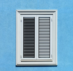 Fototapeta premium Window with shutters closeup view, sunny day on sea resort