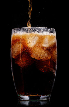 Glass Of Cola With Ice On Black Background.