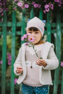 girl holding flowers in their hands.