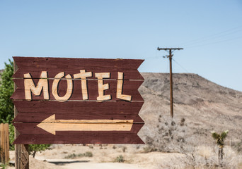 Vintage style motel sign direction in the mojave desert, California