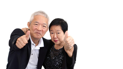 Asian senior couple in business attire showing hand gesture thum