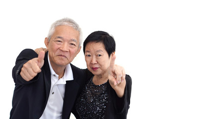 Asian senior couple in business attire showing hand gesture thum