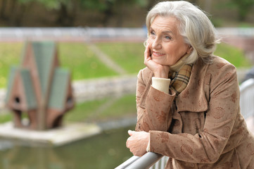 Beautiful middle-aged woman in autumn park