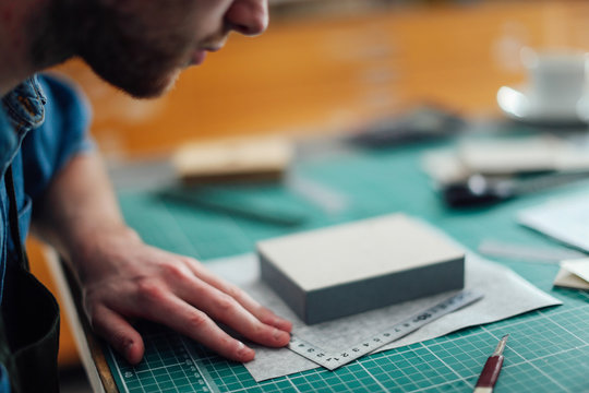 Young man working in print studio, close-up
