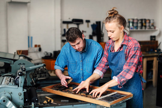 Man and woman working together in printing shop