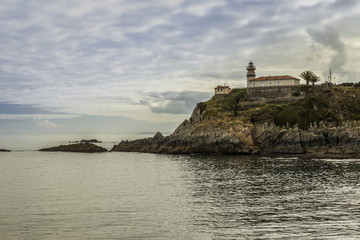 Fototapeta na wymiar Lighthouse in the cliff in Asturias, Spain