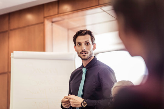Businessman questioning at boardroom presentation