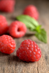 Fresh raspberries on a vintage wood background