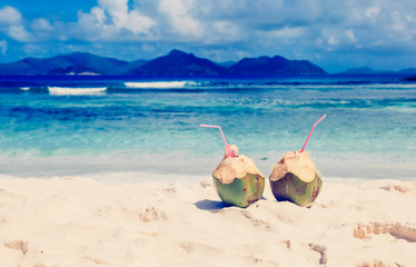 Fototapeta na wymiar coconut drinks on summer tropical sand beach