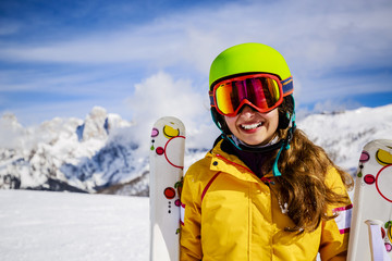 Fototapeta na wymiar Smiling girl standing with ski and arms spreading wide open on