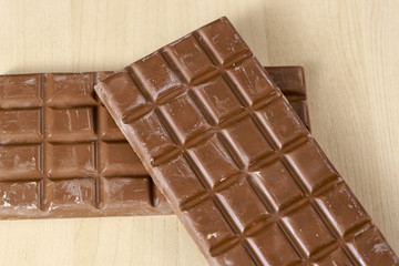 Filled chocolate bars on clear wood table