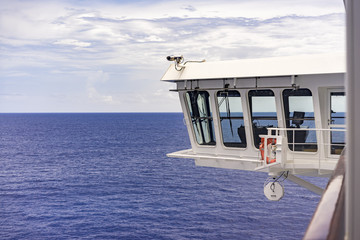 Surveillance camera on a ship or ferry mounted on the bridge watching the decks below with an ocean...