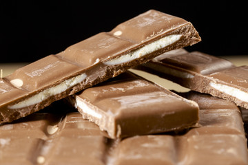 Filled chocolate bars on black background