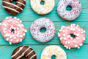Donuts on colorful wooden background
