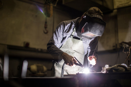 Welder wearing welding mask welding