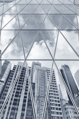 Fototapeta na wymiar Reflection of urban skyline on modern office building