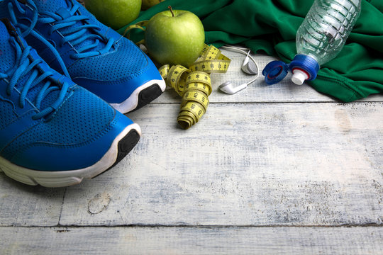 Sport stuff on wooden table, top view