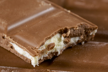 Close-up of bitten chocolate bar with fruit taste filling