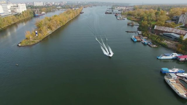 Flying over Samara city and Samara river. Boats at the dock and in the water. Autumn season time. 4K Aerial stock footage clip.
