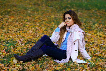 Young woman and fall yellow maple garden background. free space