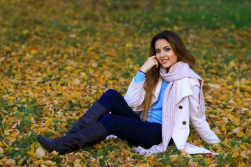 Young woman smiling and fall yellow maple garden background. free space