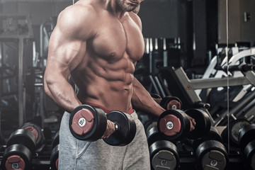 Fototapeta na wymiar Muscular man doing a exercise for biceps
