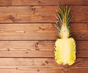 Raw cut pineapple on wooden surface table